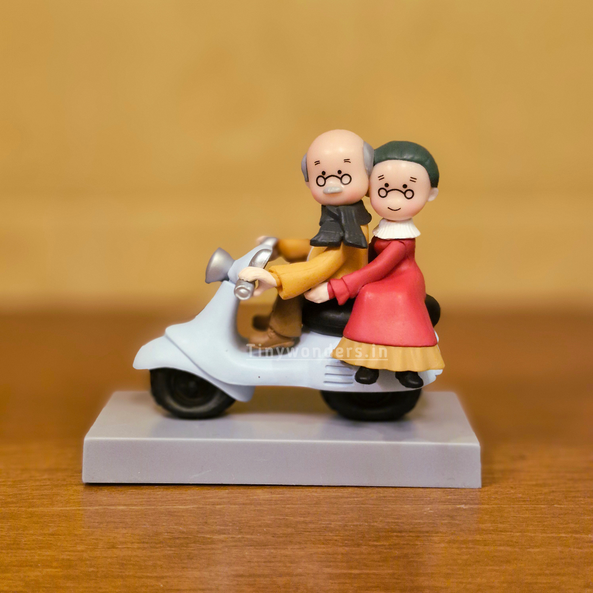 #617 Miniature Elderly Couple On Scooter ( Per Unit )