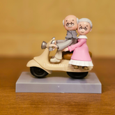 #618 Miniature Elderly Couple On Scooter ( Per Unit )